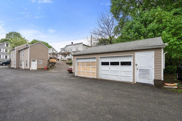 detached garage featuring a residential view