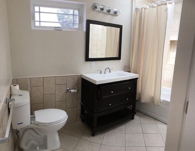 full bathroom featuring toilet, tile walls, vanity, shower / bath combo, and tile patterned flooring