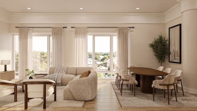 sitting room with light hardwood / wood-style flooring, crown molding, and a wealth of natural light