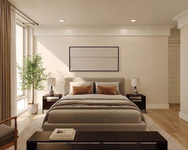 bedroom featuring crown molding, multiple windows, and light wood-type flooring