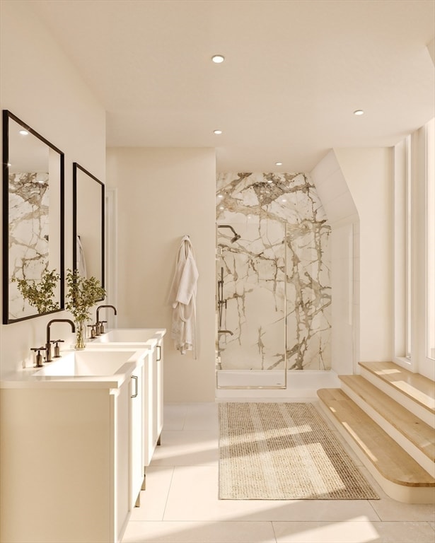 bathroom featuring vanity, a tile shower, and tile patterned floors