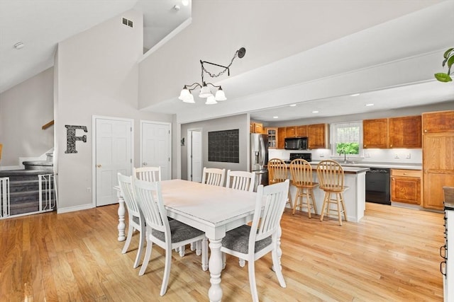 31 Fearing Hill Rd, Wareham, MA 02571 - dining room with stairway, light wood-type flooring, baseboards, recessed lighting, and a towering ceiling