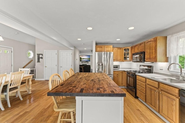 31 Fearing Hill Rd, Wareham, MA 02571 - kitchen featuring black appliances, a sink, butcher block countertops, light wood-style flooring, and a kitchen island