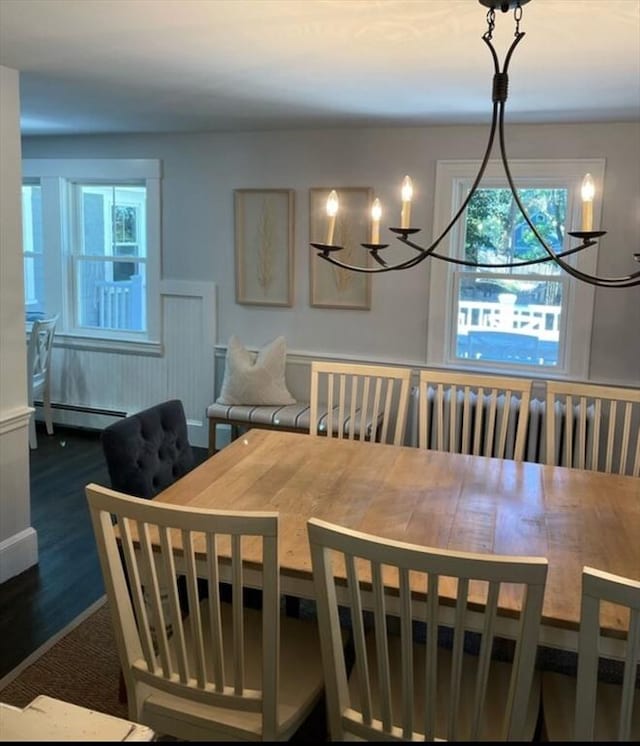 dining area featuring dark wood-type flooring and baseboard heating