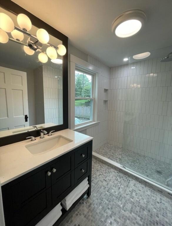 bathroom featuring vanity, tiled shower, tile patterned floors, and a chandelier