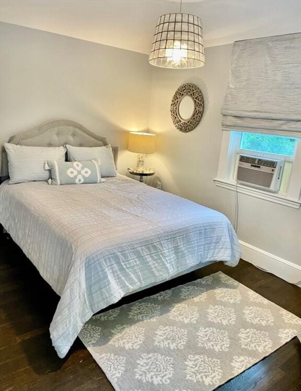 bedroom with dark wood-type flooring and cooling unit