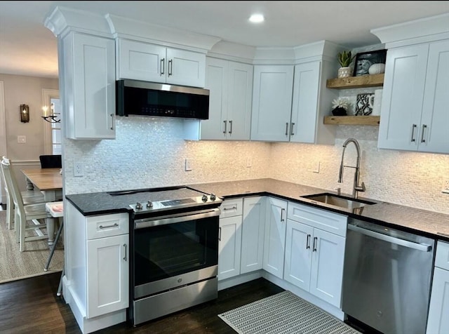 kitchen featuring sink, dark wood-type flooring, stainless steel appliances, and white cabinets