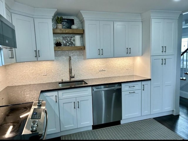 kitchen with appliances with stainless steel finishes, sink, and white cabinets