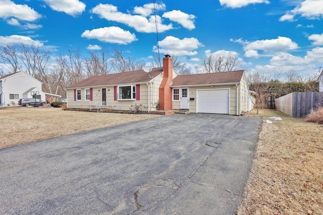 ranch-style home featuring fence, a garage, driveway, and a chimney