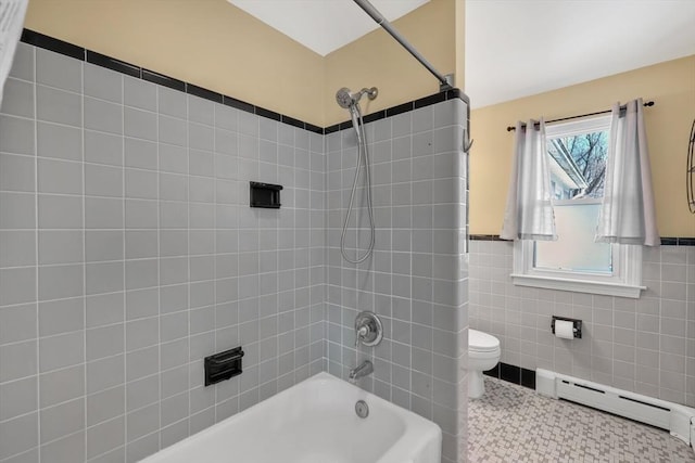 full bathroom featuring tile patterned floors, toilet, a baseboard heating unit, tile walls, and bathtub / shower combination