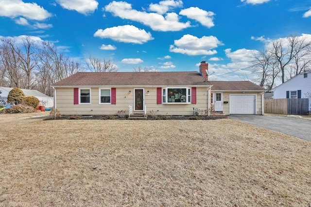 single story home featuring a front lawn, driveway, fence, a garage, and a chimney