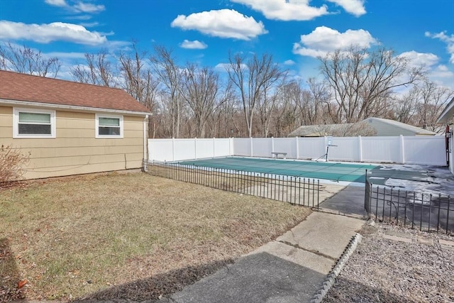 view of swimming pool with a patio, a fenced backyard, a fenced in pool, and a lawn