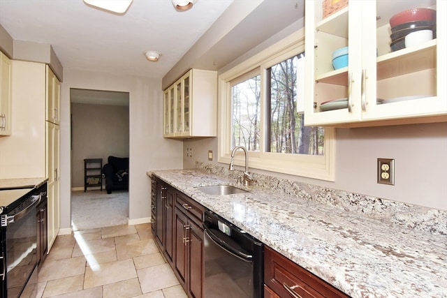 kitchen featuring sink, light stone countertops, dark brown cabinets, light tile patterned flooring, and stainless steel appliances