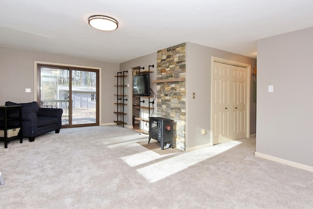 living room with light colored carpet and a wood stove