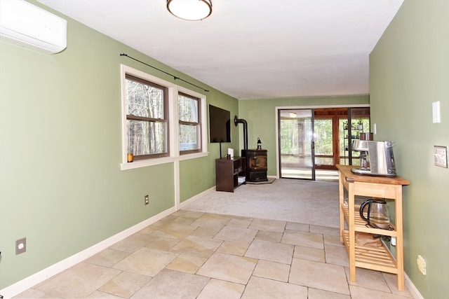 carpeted entryway featuring a wood stove and a wall mounted AC