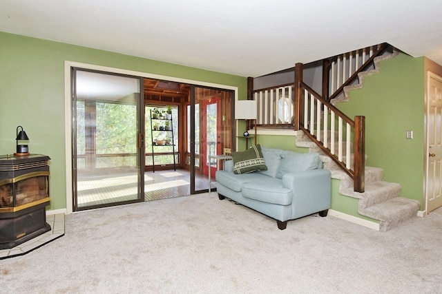 living room featuring carpet flooring and a wood stove