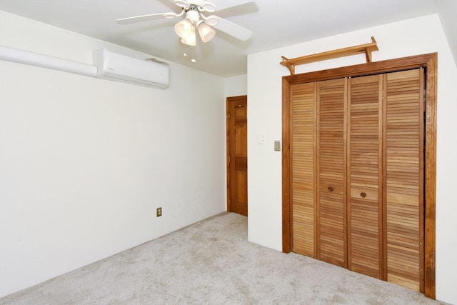 unfurnished bedroom featuring ceiling fan, light colored carpet, a wall unit AC, and a closet