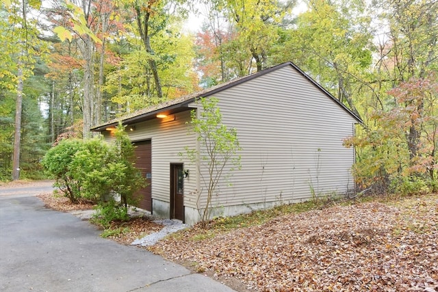 view of side of property featuring an outbuilding and a garage