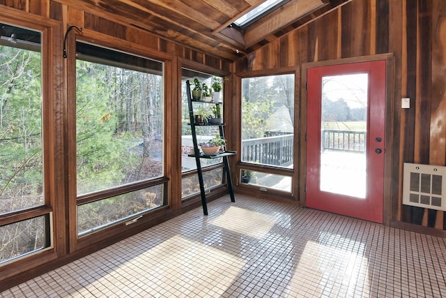 unfurnished sunroom featuring heating unit, wood ceiling, and vaulted ceiling