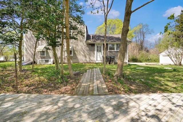 view of front of home with a wooden deck and a front yard
