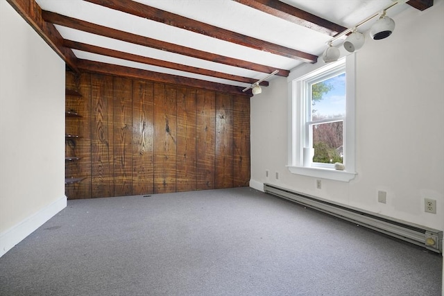 carpeted empty room featuring a baseboard radiator and beamed ceiling
