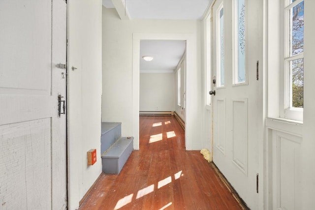 interior space with a baseboard heating unit and hardwood / wood-style flooring