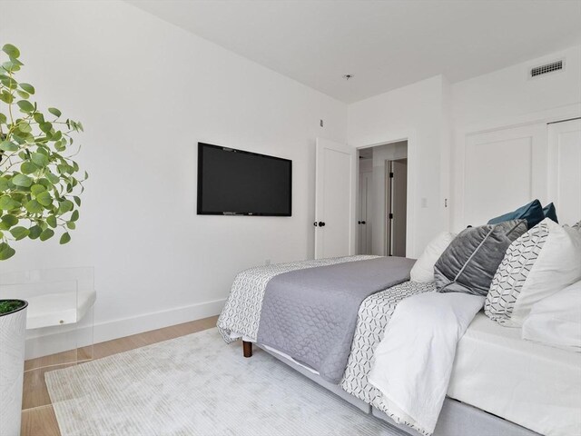 27 Dixwell Unit 11, Boston, MA 02119 - bedroom with a closet, wood finished floors, and baseboards