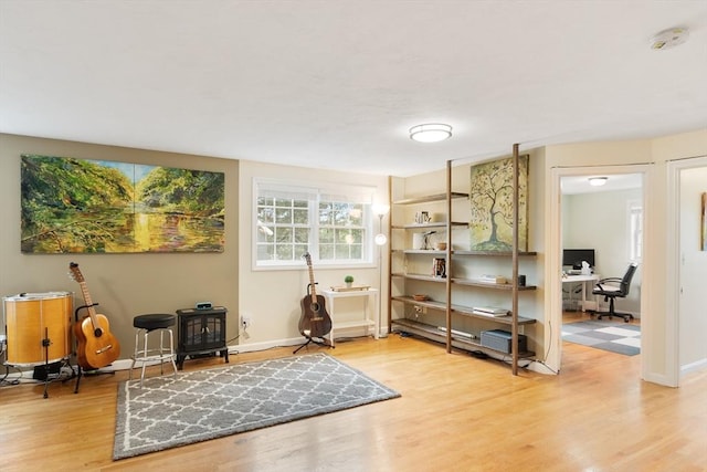 4 Fiske Ave, Chelmsford, MA 01863 - sitting room featuring a wood stove, a desk, and wood finished floors