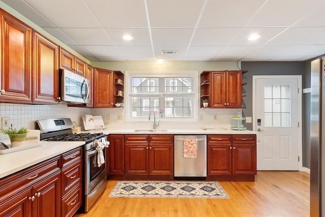 4 Fiske Ave, Chelmsford, MA 01863 - kitchen featuring appliances with stainless steel finishes, open shelves, a paneled ceiling, light wood-style floors, and recessed lighting