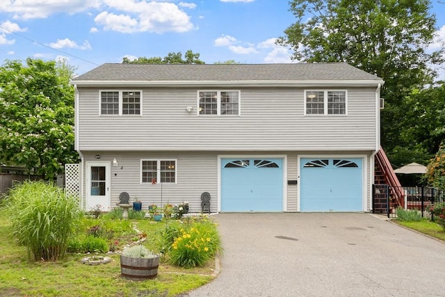 4 Fiske Ave, Chelmsford, MA 01863 - view of front of house with a garage and driveway