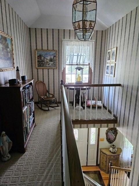 interior space featuring carpet flooring and an inviting chandelier