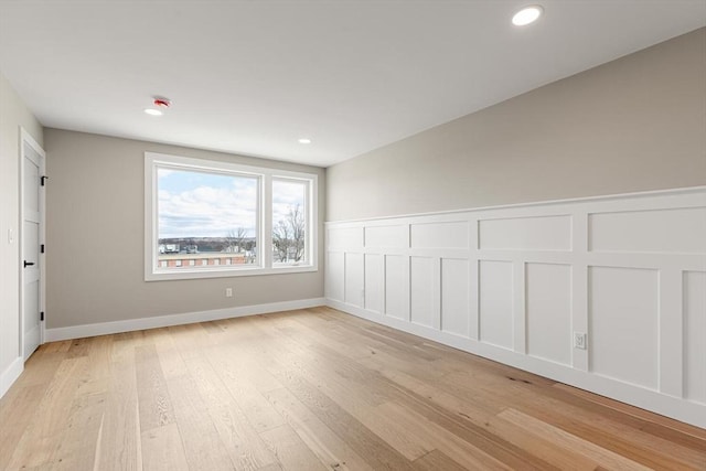 308 Newton St, Waltham, MA 02453 - empty room with light wood-style floors, a decorative wall, a wainscoted wall, and recessed lighting
