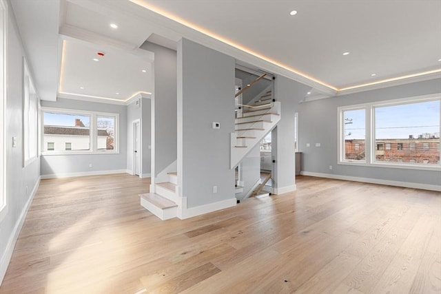 308 Newton St, Waltham, MA 02453 - unfurnished living room featuring stairs, light wood-type flooring, healthy amount of natural light, recessed lighting, and crown molding