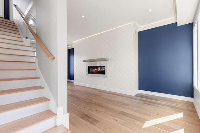 308 Newton St, Waltham, MA 02453 - stairs featuring wood finished floors, a glass covered fireplace, baseboards, and recessed lighting