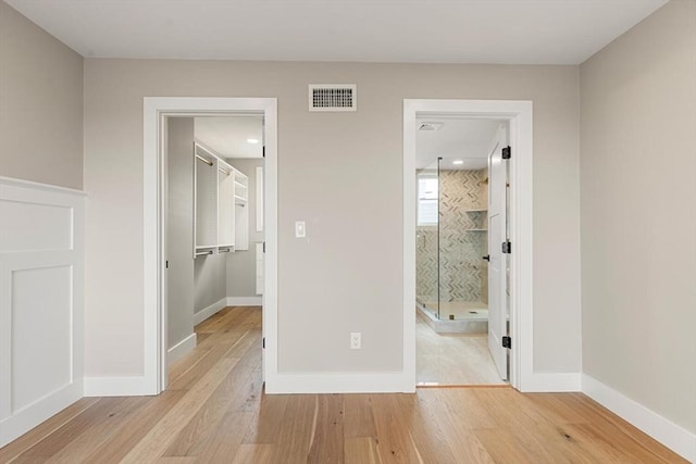 308 Newton St, Waltham, MA 02453 - unfurnished bedroom with wood finished floors, a spacious closet, baseboards, a closet, and recessed lighting