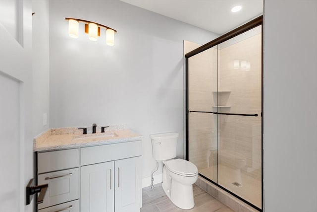 308 Newton St, Waltham, MA 02453 - bathroom with toilet, a shower stall, vanity, wood finished floors, and recessed lighting