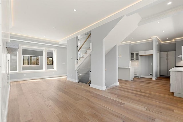 308 Newton St, Waltham, MA 02453 - unfurnished living room with light wood-type flooring, stairway, baseboards, crown molding, and recessed lighting