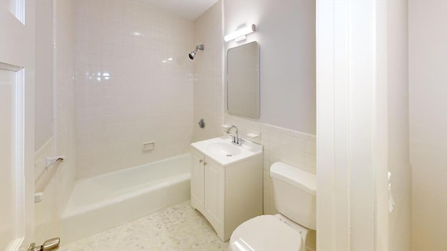 bathroom featuring toilet, vanity, and shower / bath combination