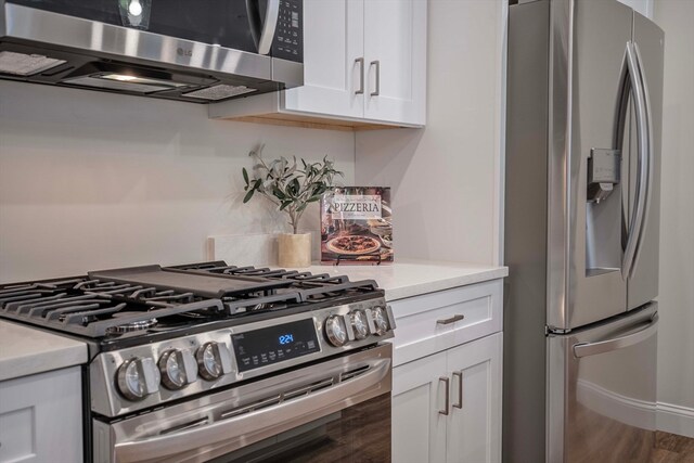 kitchen featuring white cabinets, hardwood / wood-style floors, and stainless steel appliances