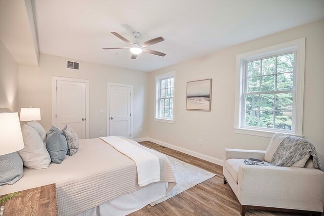 bedroom with hardwood / wood-style floors and ceiling fan