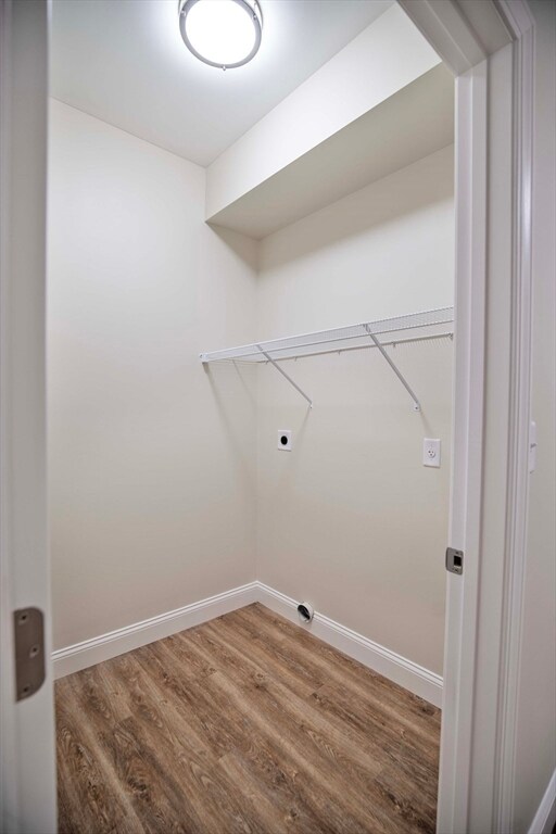 laundry room with wood-type flooring and electric dryer hookup