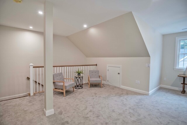 unfurnished room featuring light carpet and vaulted ceiling