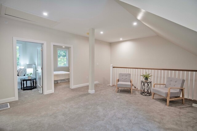 unfurnished room featuring light colored carpet and lofted ceiling