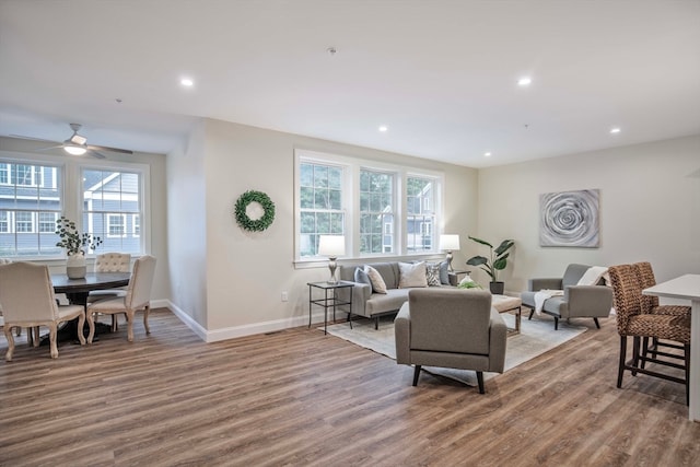 living room featuring ceiling fan and hardwood / wood-style flooring