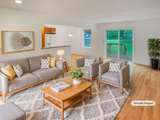 living area featuring light wood-type flooring and recessed lighting