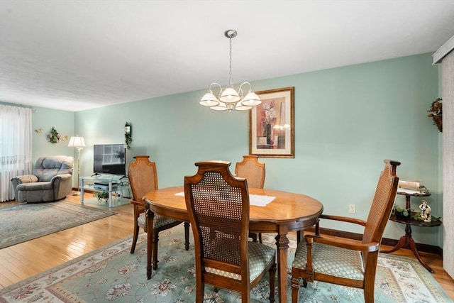55 Glen Rd, Wilmington, MA 01887 - dining space featuring a chandelier, light wood-style floors, and baseboards