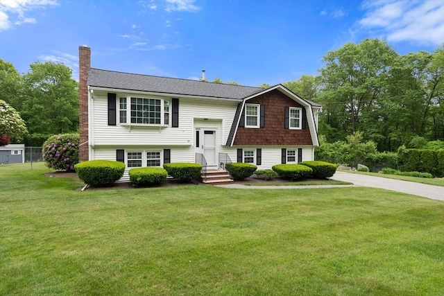 55 Glen Rd, Wilmington, MA 01887 - bi-level home featuring a chimney and roof with shingles