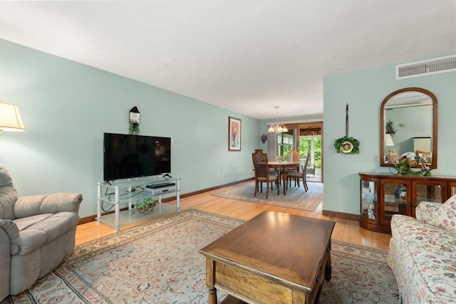 55 Glen Rd, Wilmington, MA 01887 - living area featuring light wood-type flooring, a chandelier, and baseboards