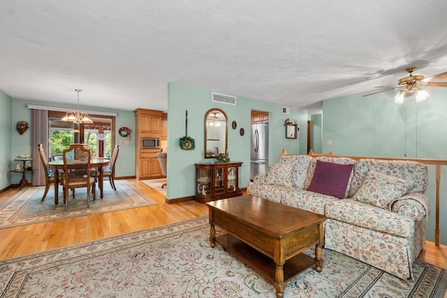 55 Glen Rd, Wilmington, MA 01887 - living area with light wood-style floors, a chandelier, baseboards, and a ceiling fan