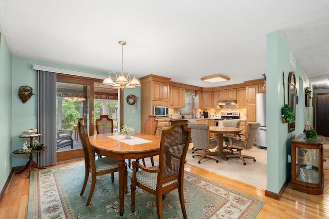 55 Glen Rd, Wilmington, MA 01887 - dining area with healthy amount of natural light, light wood-style flooring, a chandelier, and baseboards